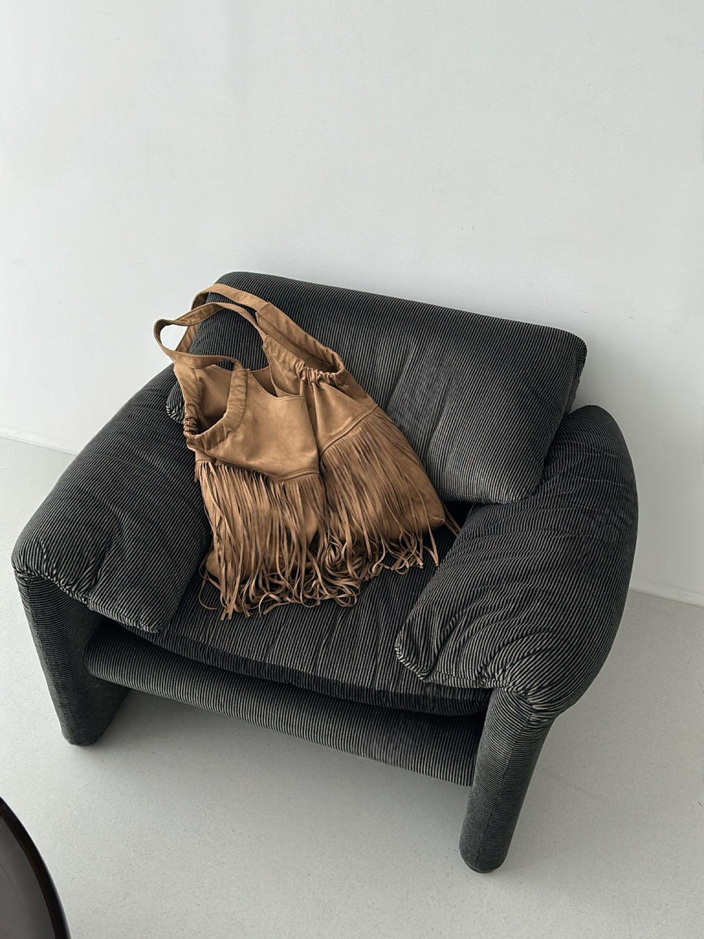 Suede Fringe Shoulder Bag Camel on chair styled