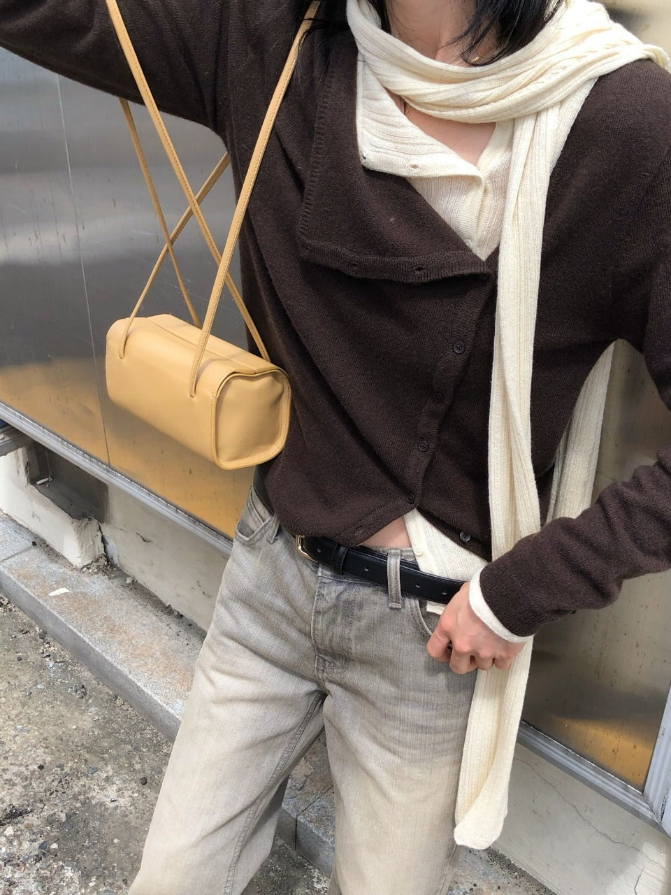 Close view of melange gray asymmetric button knit cardigan