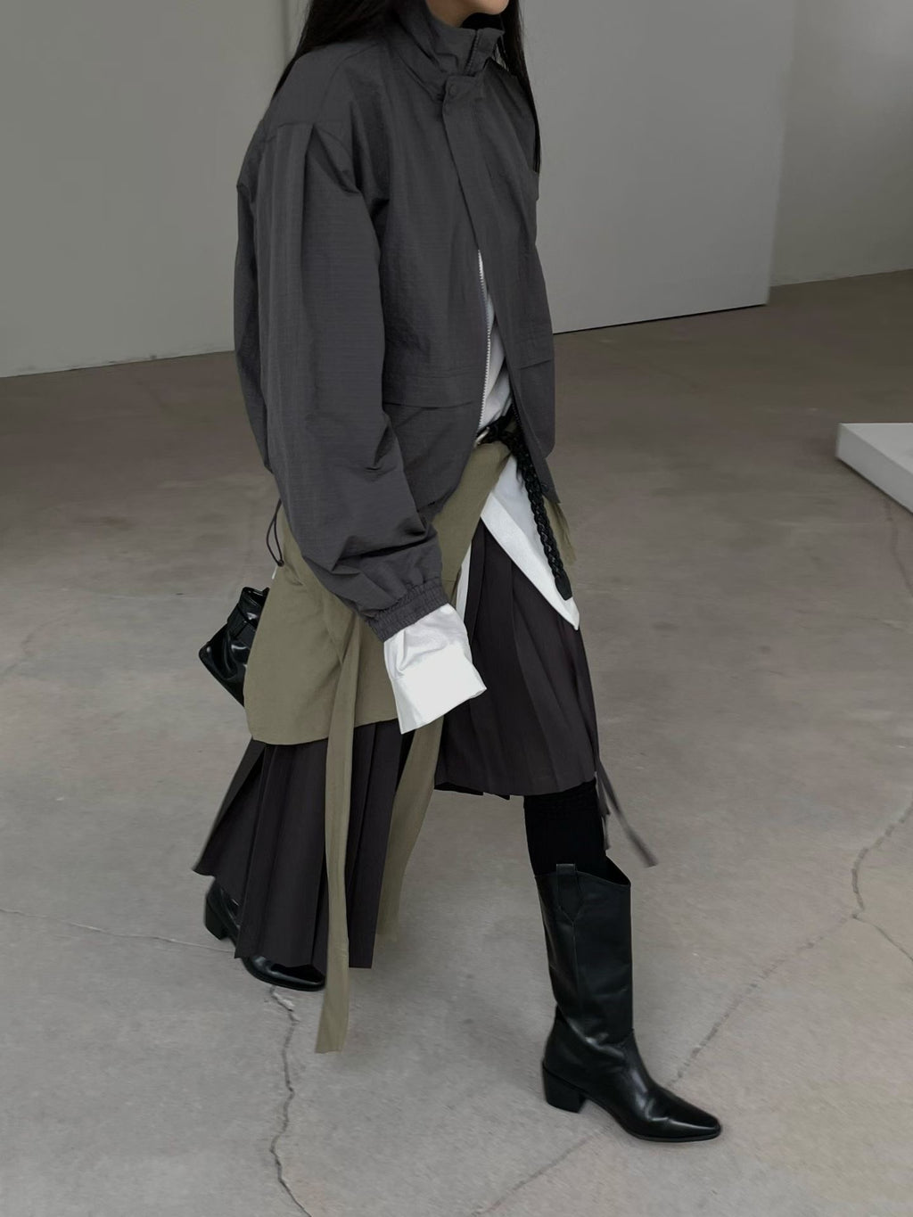 Side view of charcoal high-neck jacket with elasticated cuffs