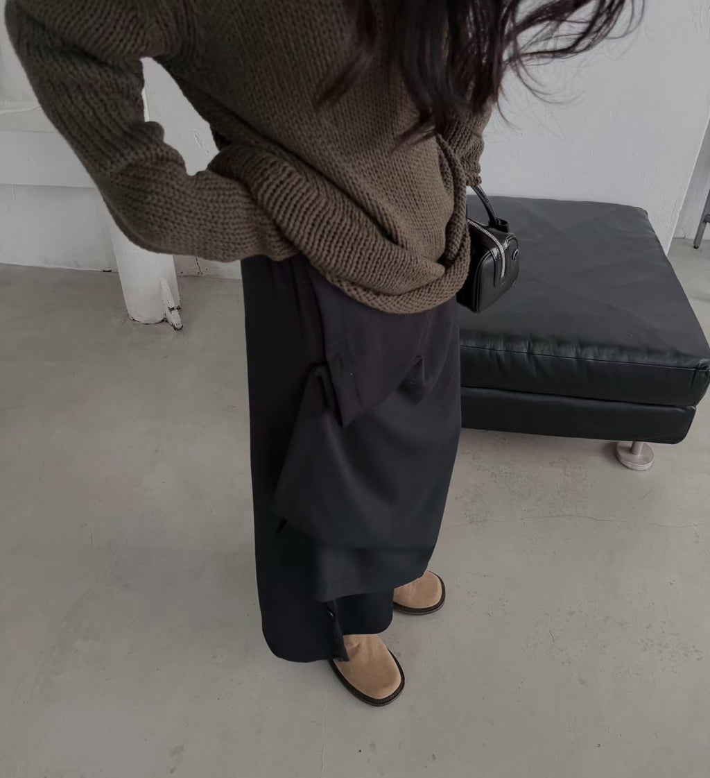 Mirror view of a charcoal maxi skirt in a straight silhouette styled with a black top.