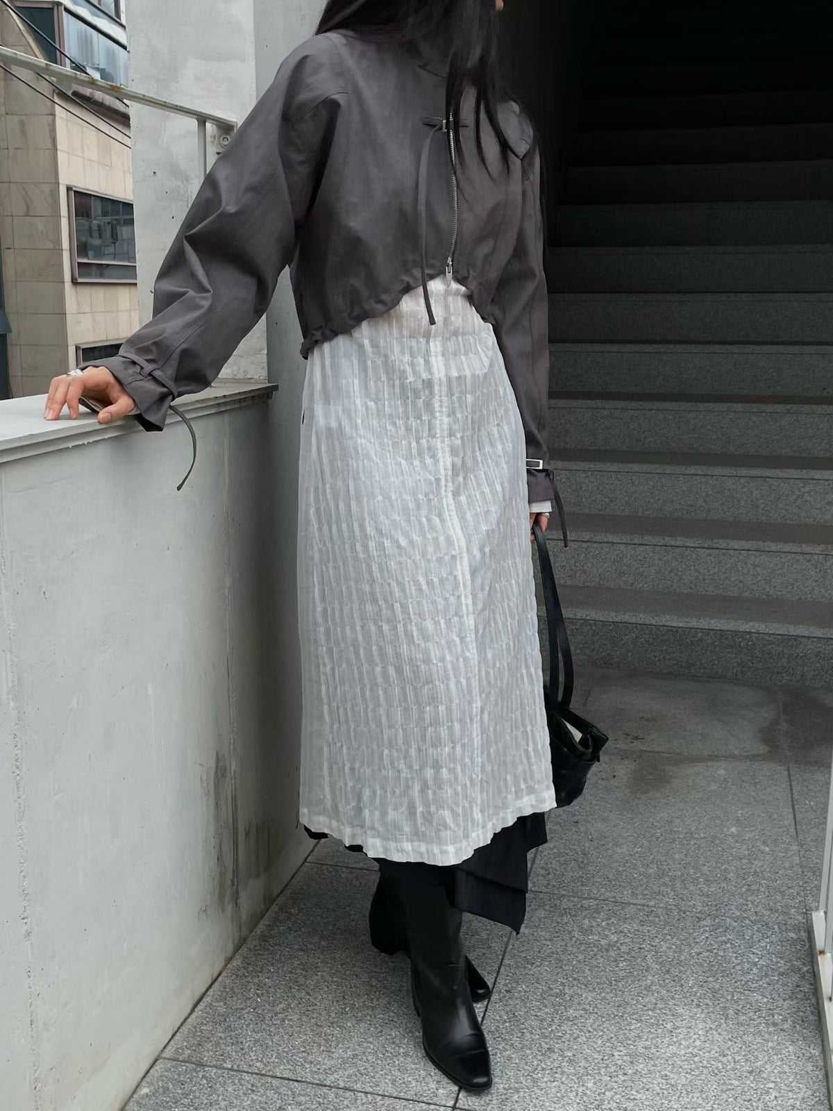 Charcoal long-sleeve bolero jacket styled with a white dress and black boots