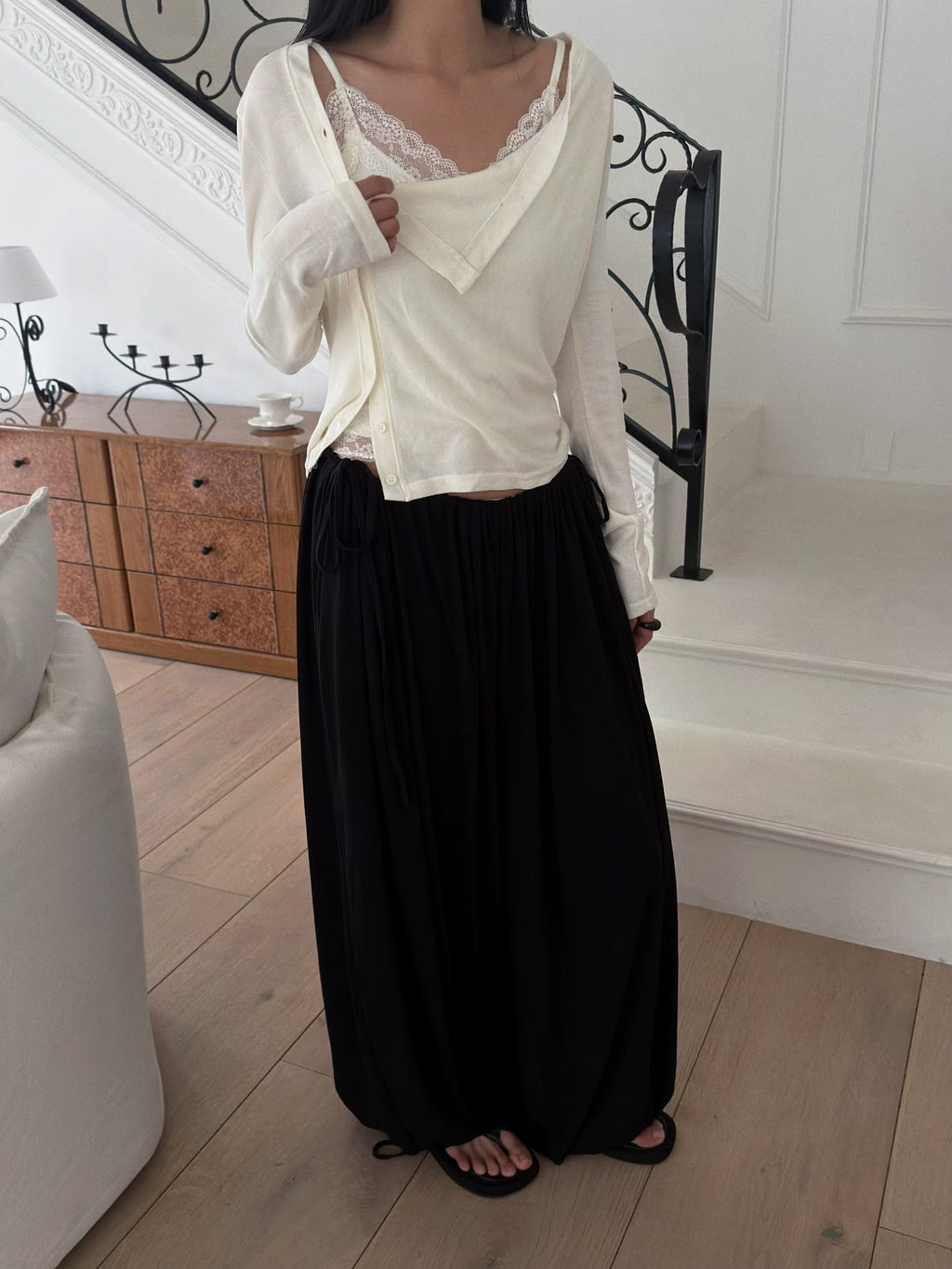 Full-length outfit with a charcoal draped cardigan and black wide leg trousers.