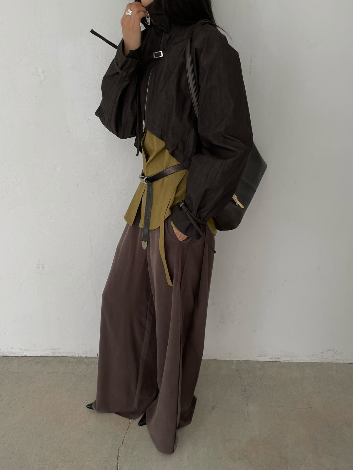 Black long-sleeve bolero jacket styled with a khaki shirt and brown wide-leg trousers