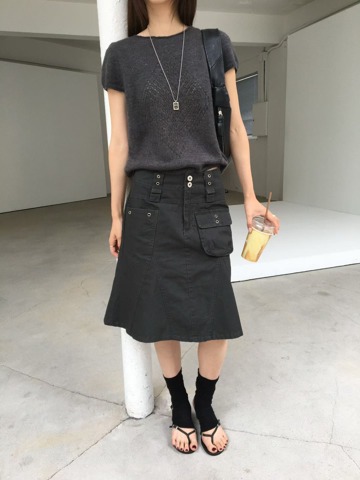 Nuage cargo skirts in Charcoal and Khaki on hangers showing front pockets and eyelet details.