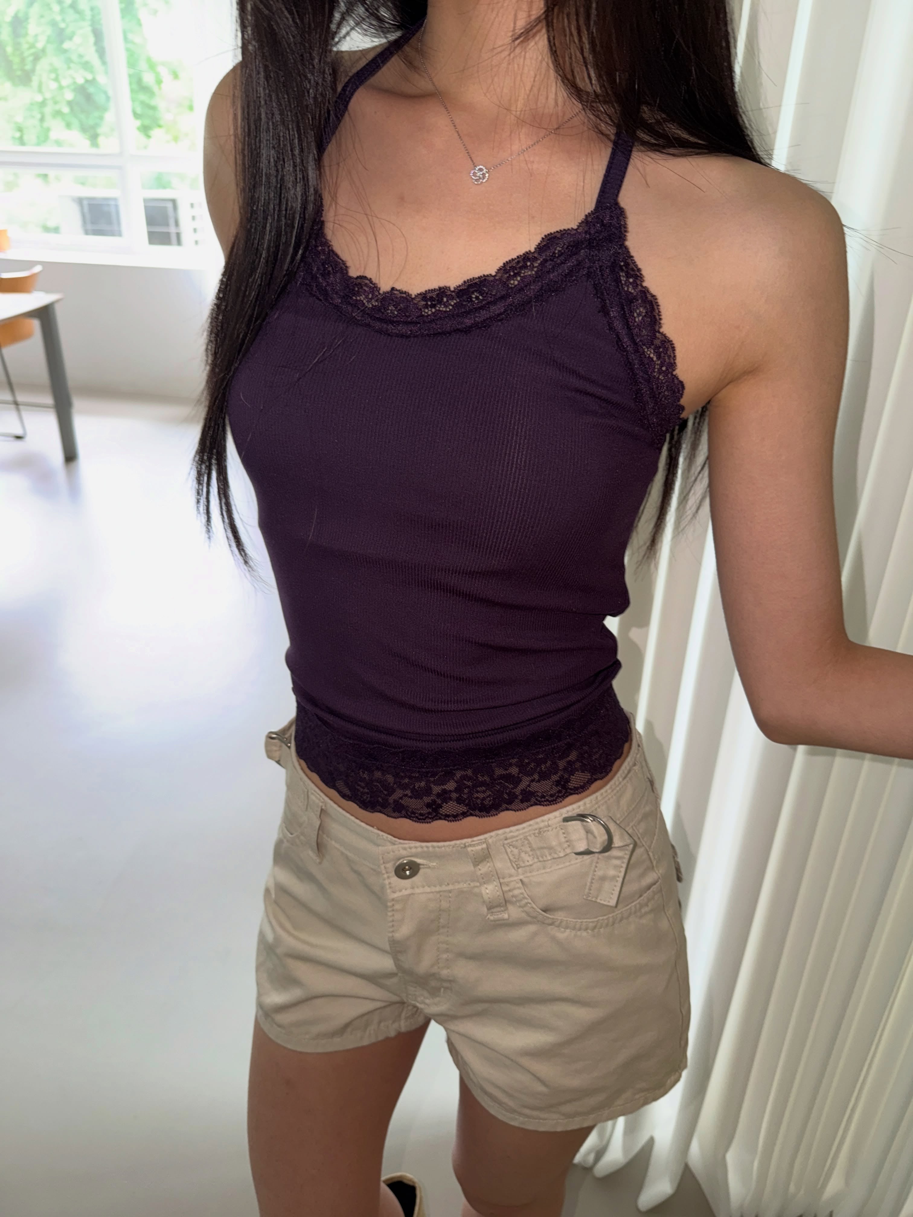 Poésie lace trim halter tank top in Purple, seated front view with lace hem detail