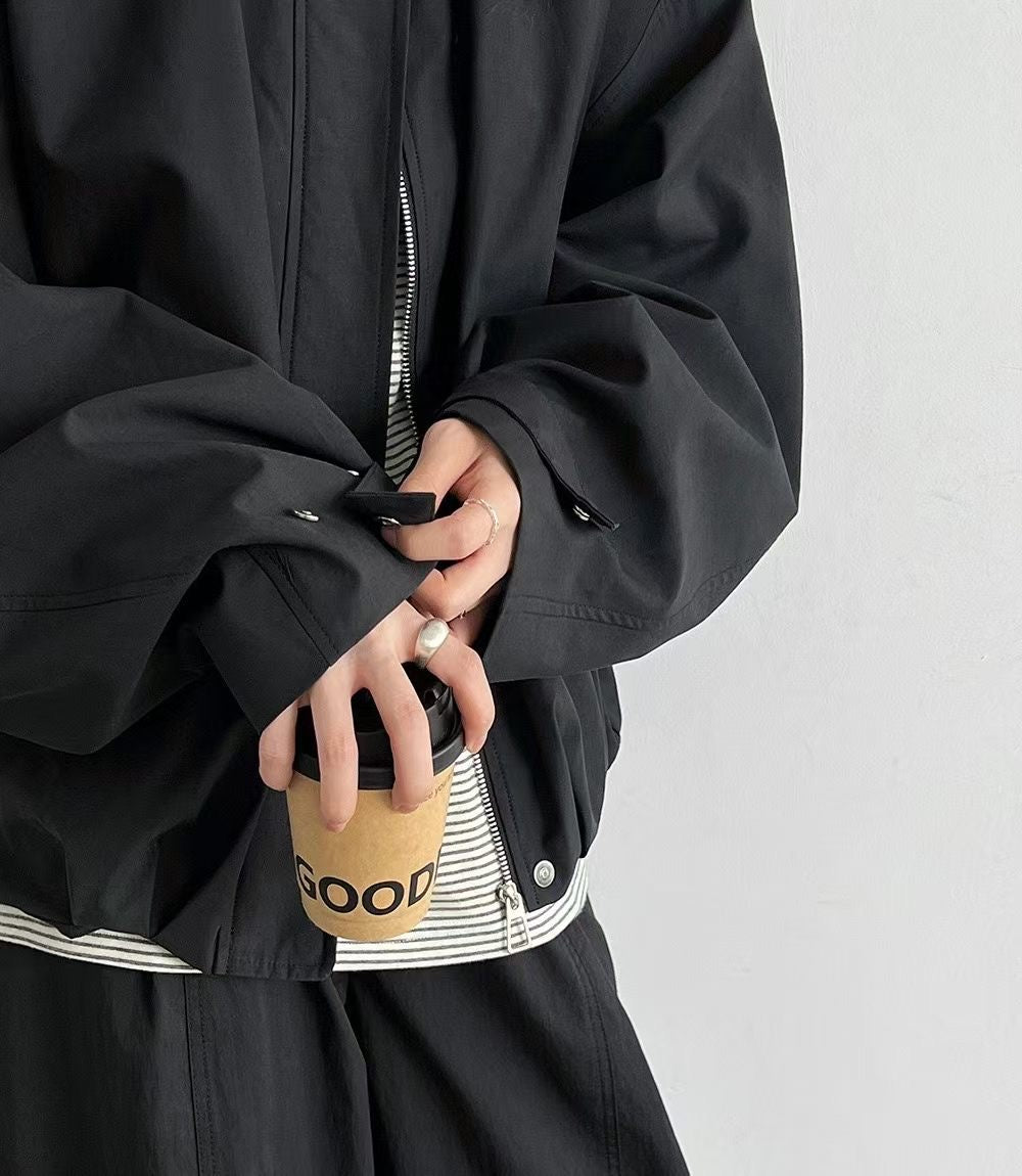 Front view of an ivory zip-up jacket with hands in the side pockets.