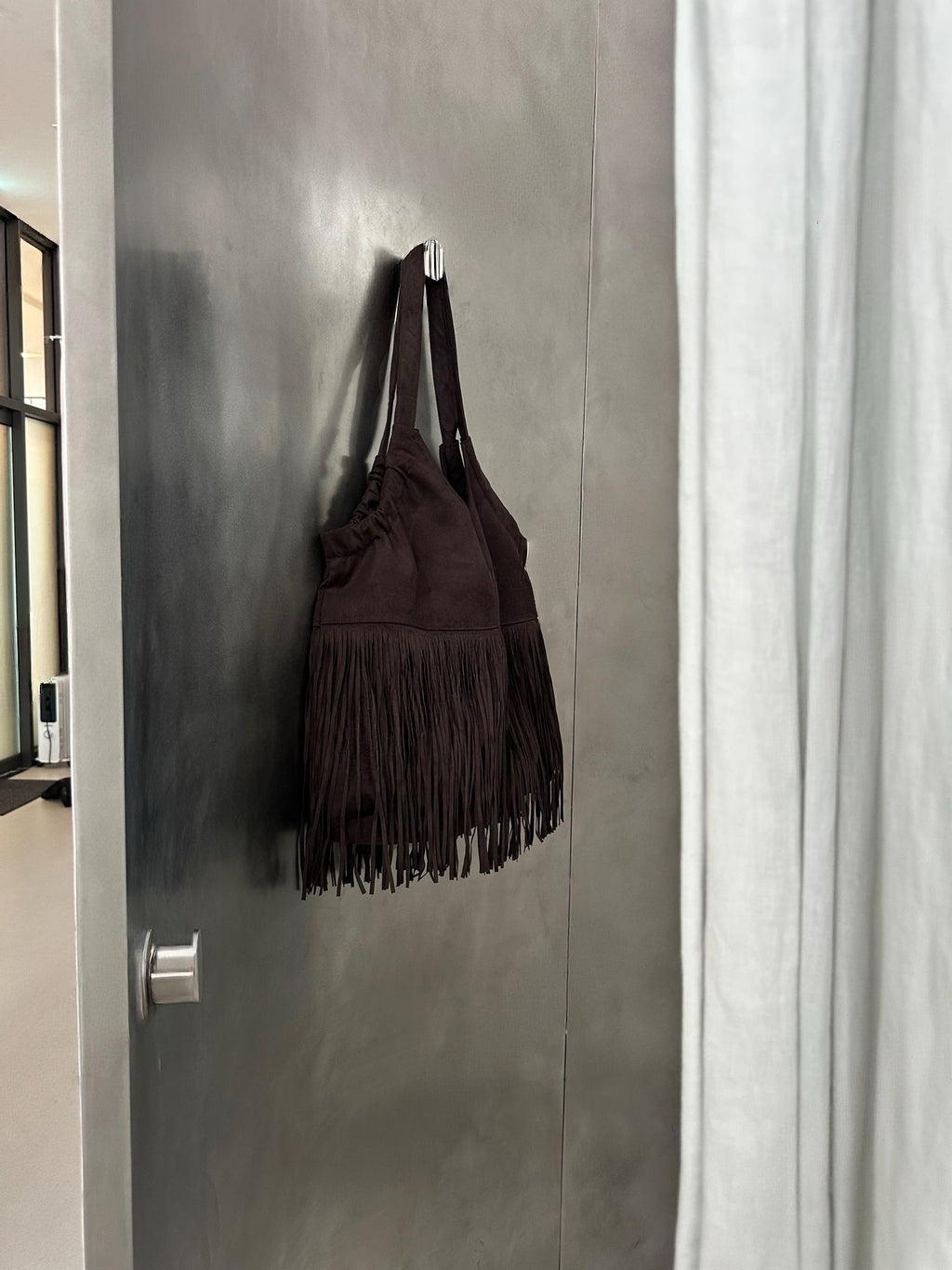Suede Fringe Shoulder Bag Dark Brown on door hook