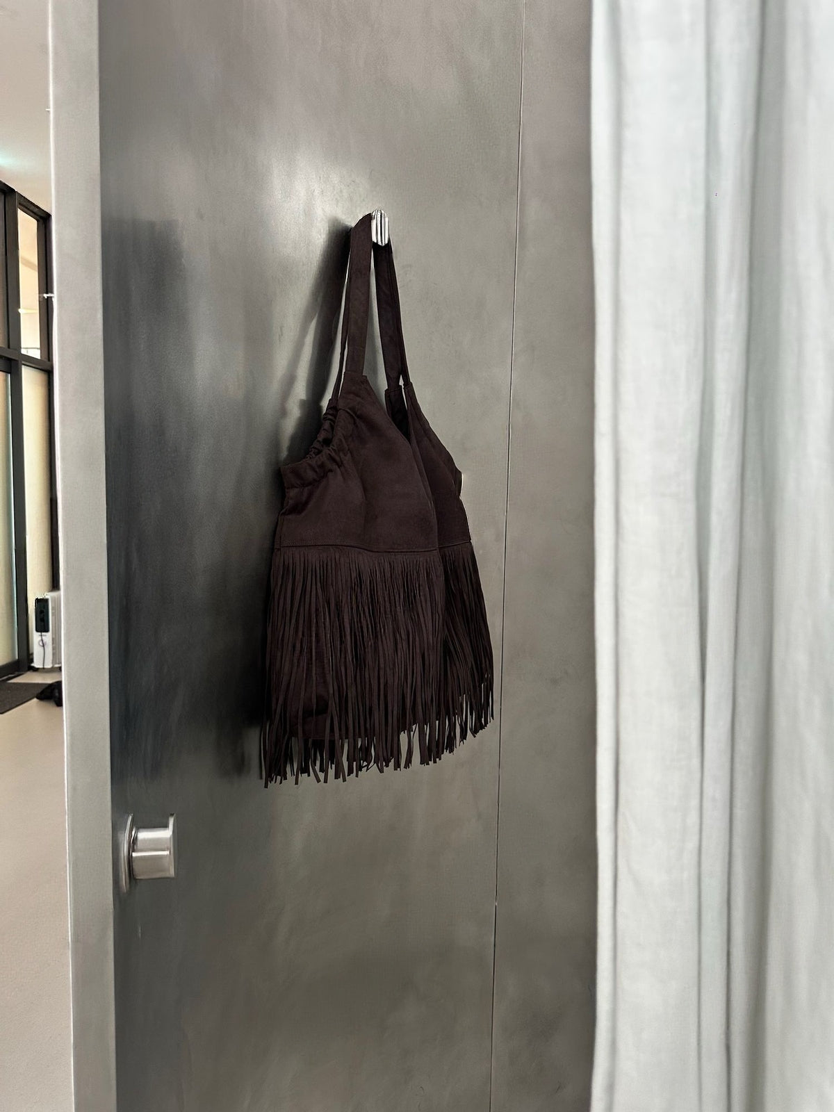 Suede Fringe Shoulder Bag Dark Brown on door hook