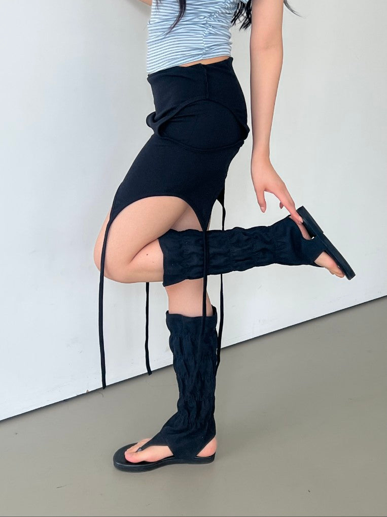 Askhaki square neck tank top with side tie strings in Black, styled on model front view with black mini skirt and leg warmers