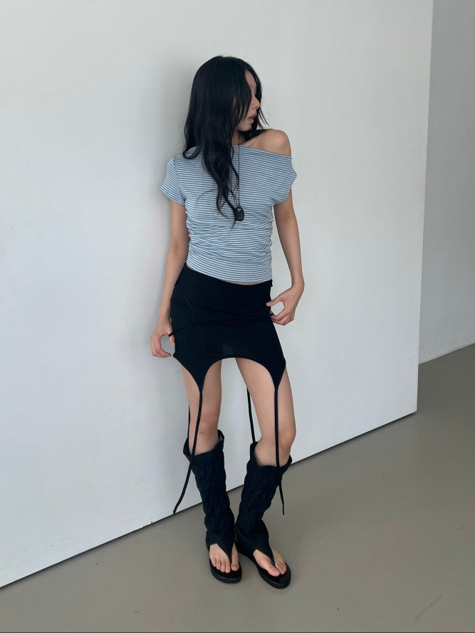 Askhaki square neck tank top with side tie strings in Black, styled on model front view with black mini skirt and leg warmers arms crossed