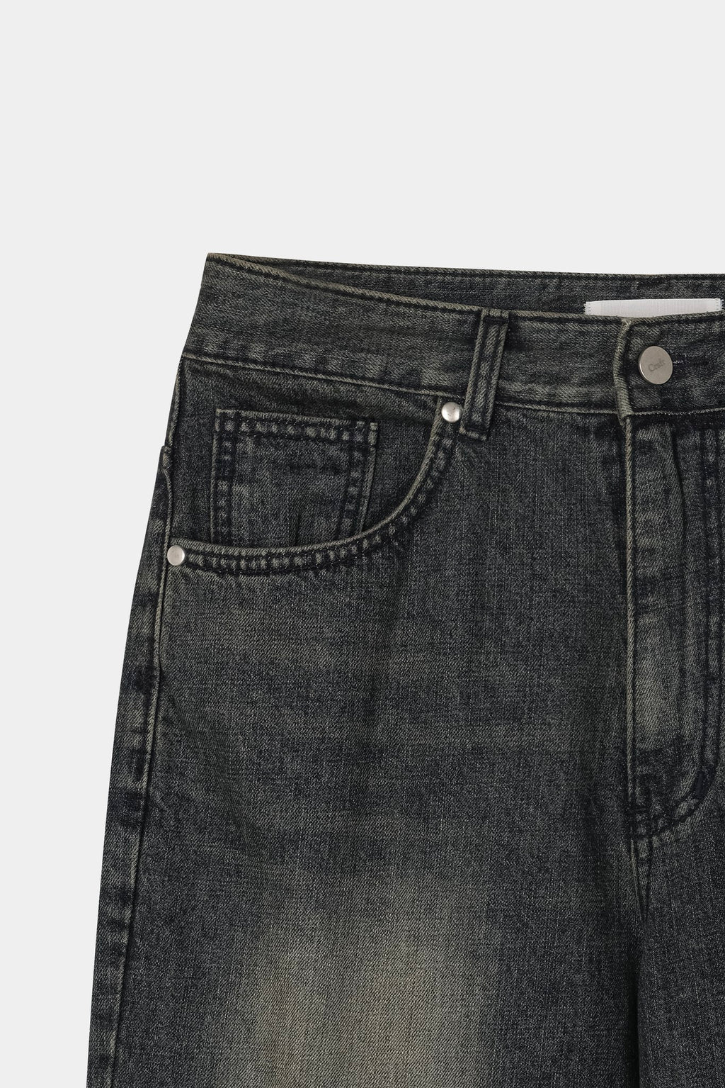 Back pocket and yoke detail on dark indigo washed denim jeans