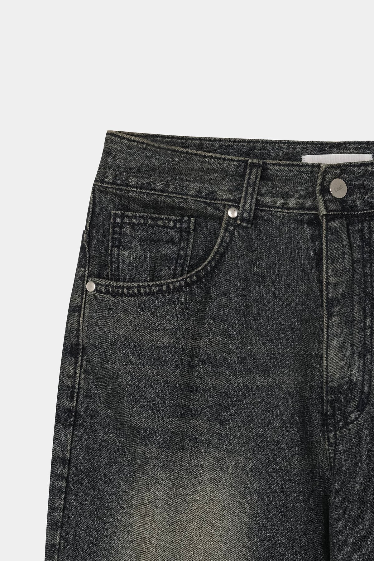 Back pocket and yoke detail on dark indigo washed denim jeans