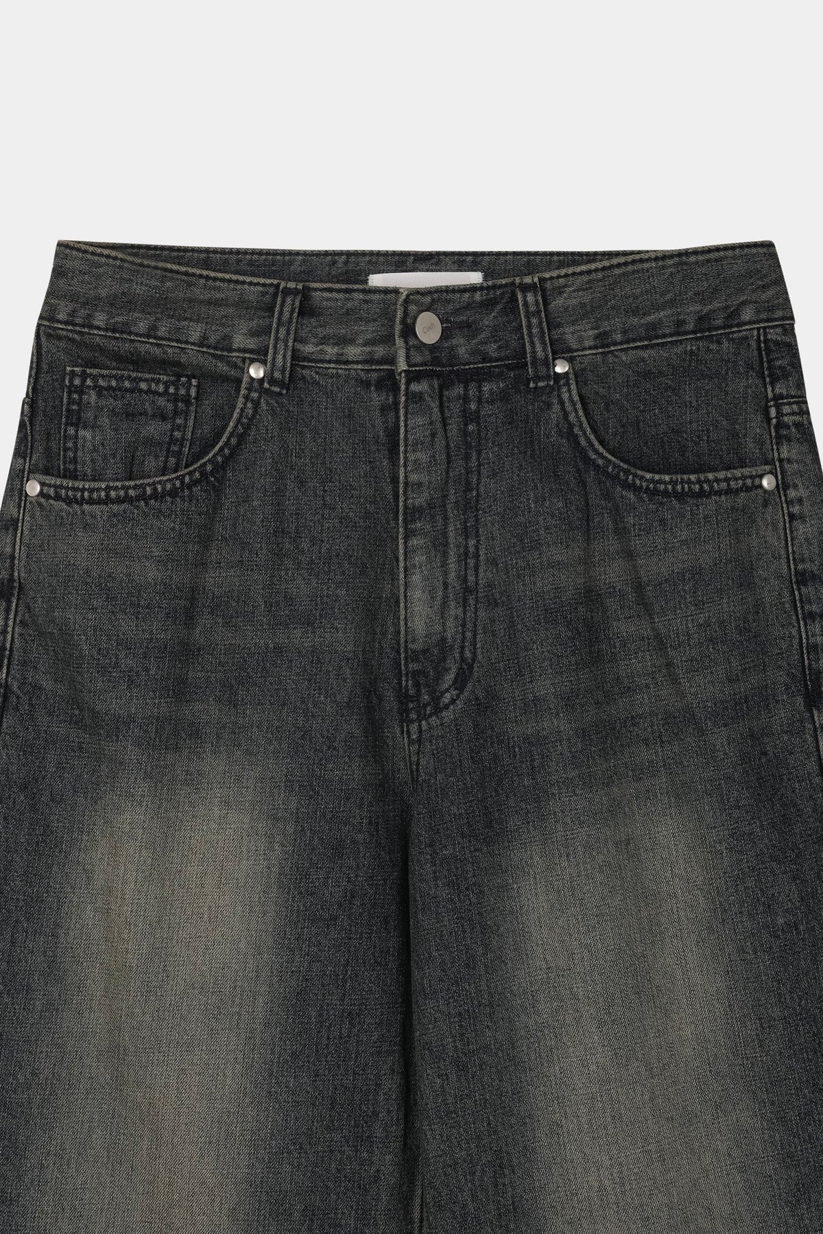 Dark indigo denim front pocket with nickel rivets and engraved button
