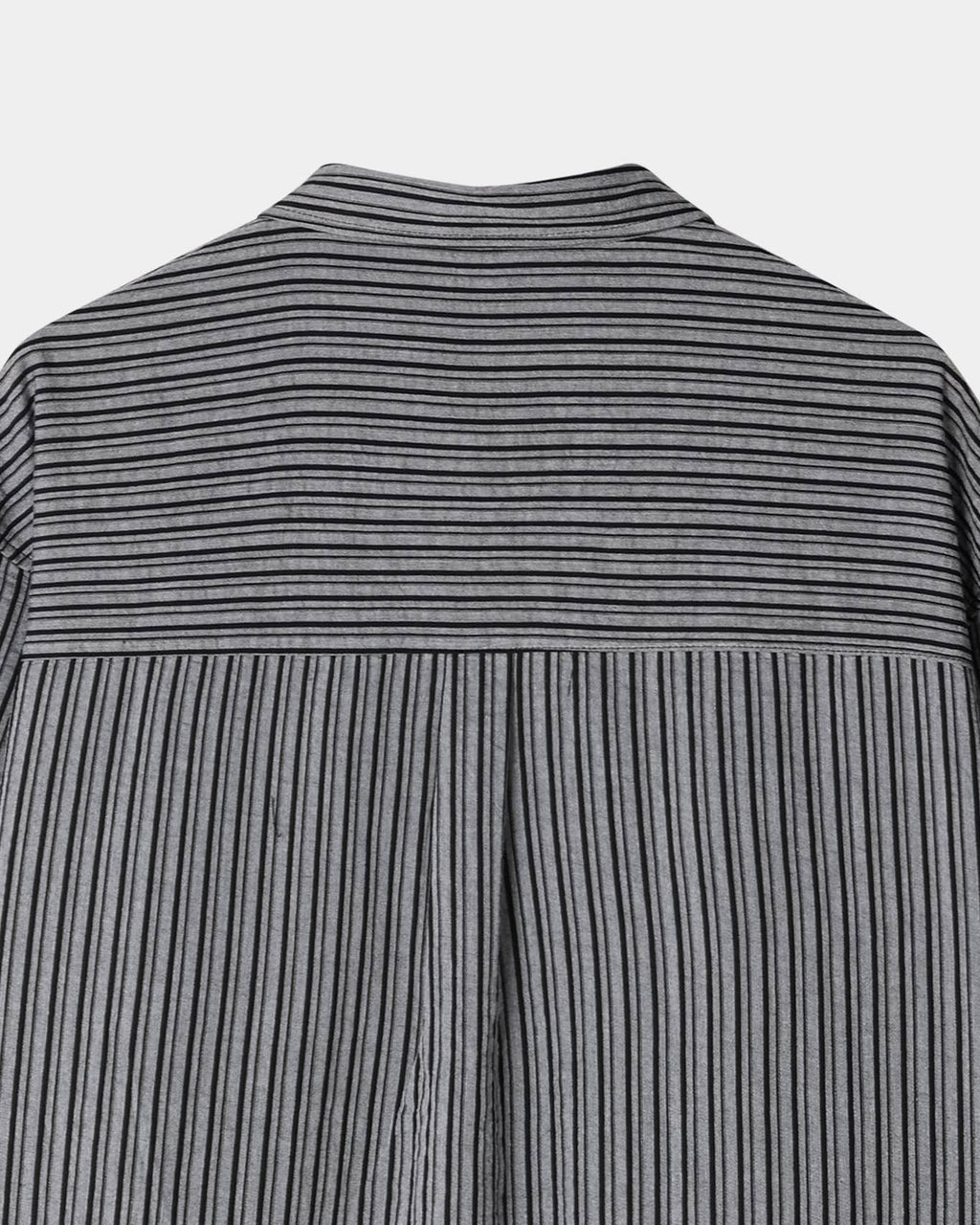 Back yoke and center pleat detail on a black men's pinstripe shirt