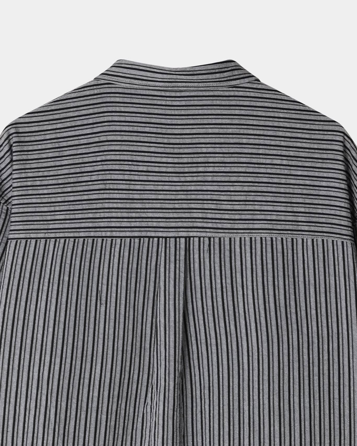 Back yoke and center pleat detail on a black men's pinstripe shirt