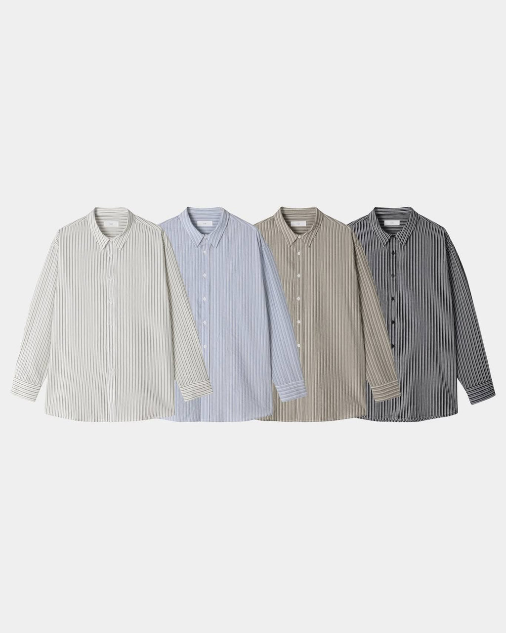 Pointed collar and button placket detail on a black cotton pinstripe shirt