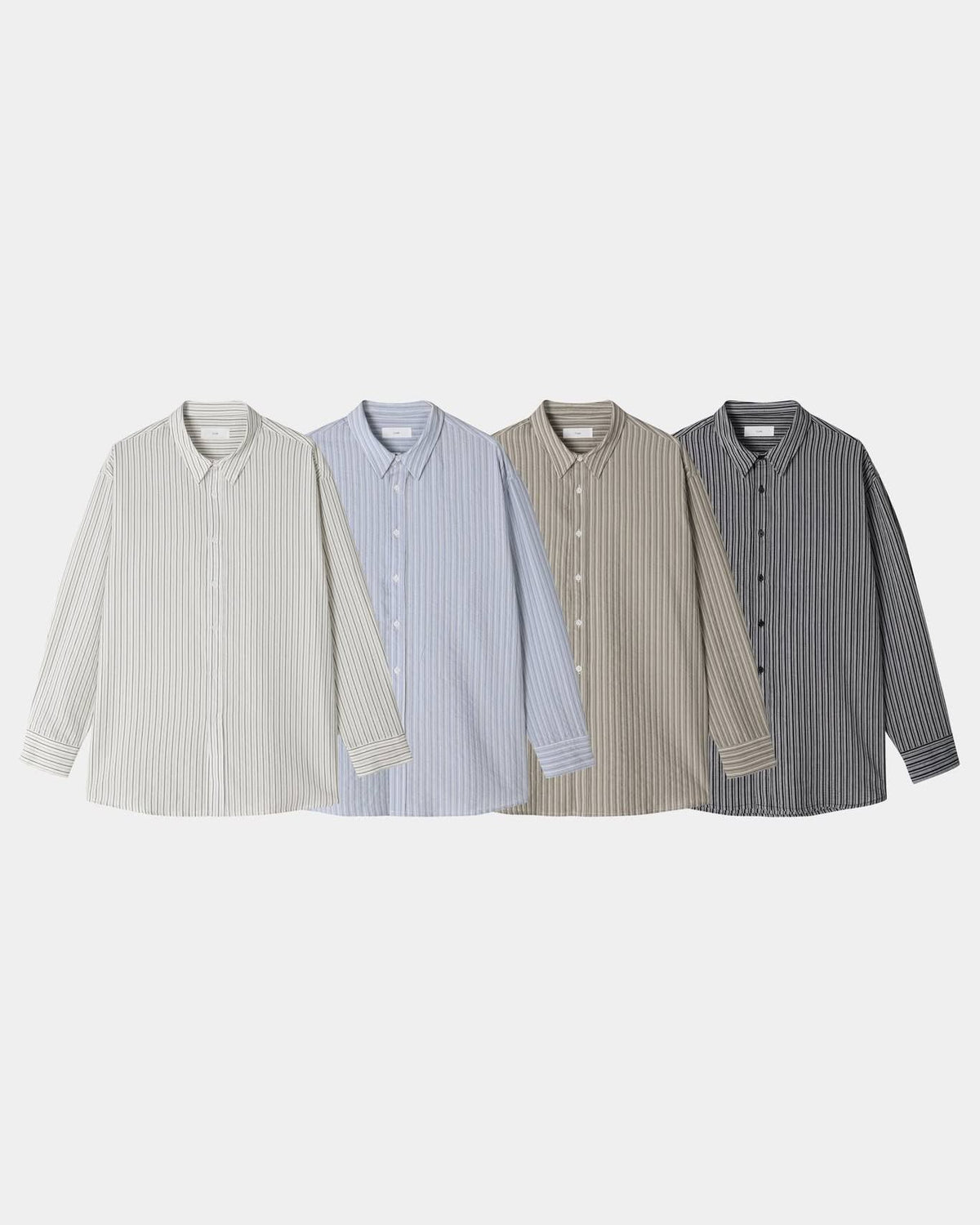 Pointed collar and button placket detail on a black cotton pinstripe shirt