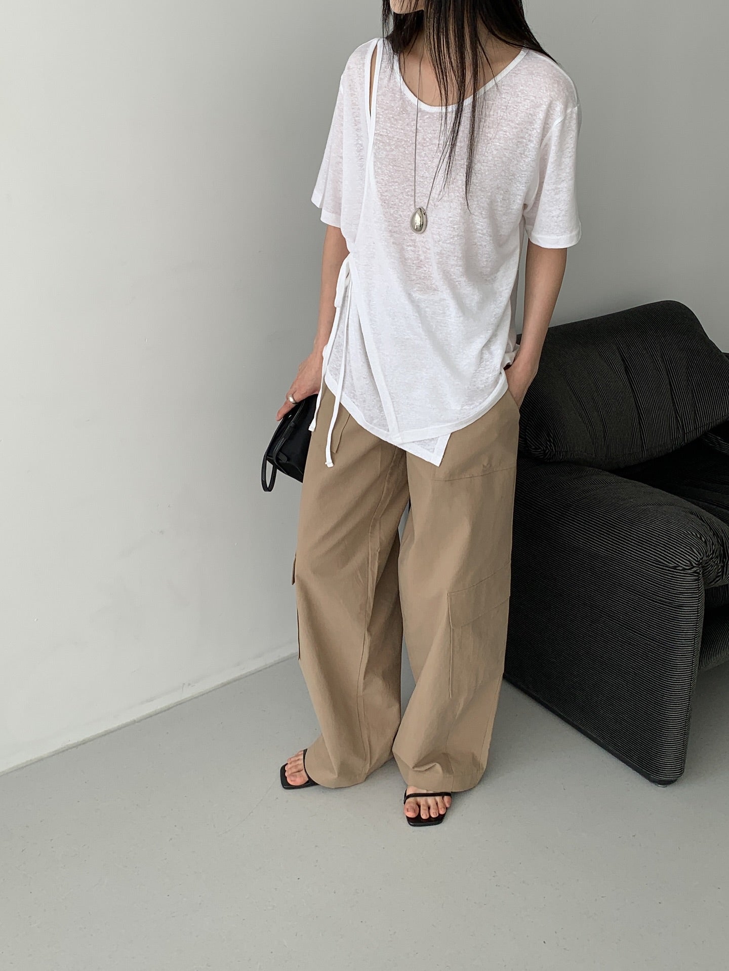 Vivel multi cargo pocket wide leg pants in Dark Beige, styled on model front view close-up cargo pocket and roll-up hem detail