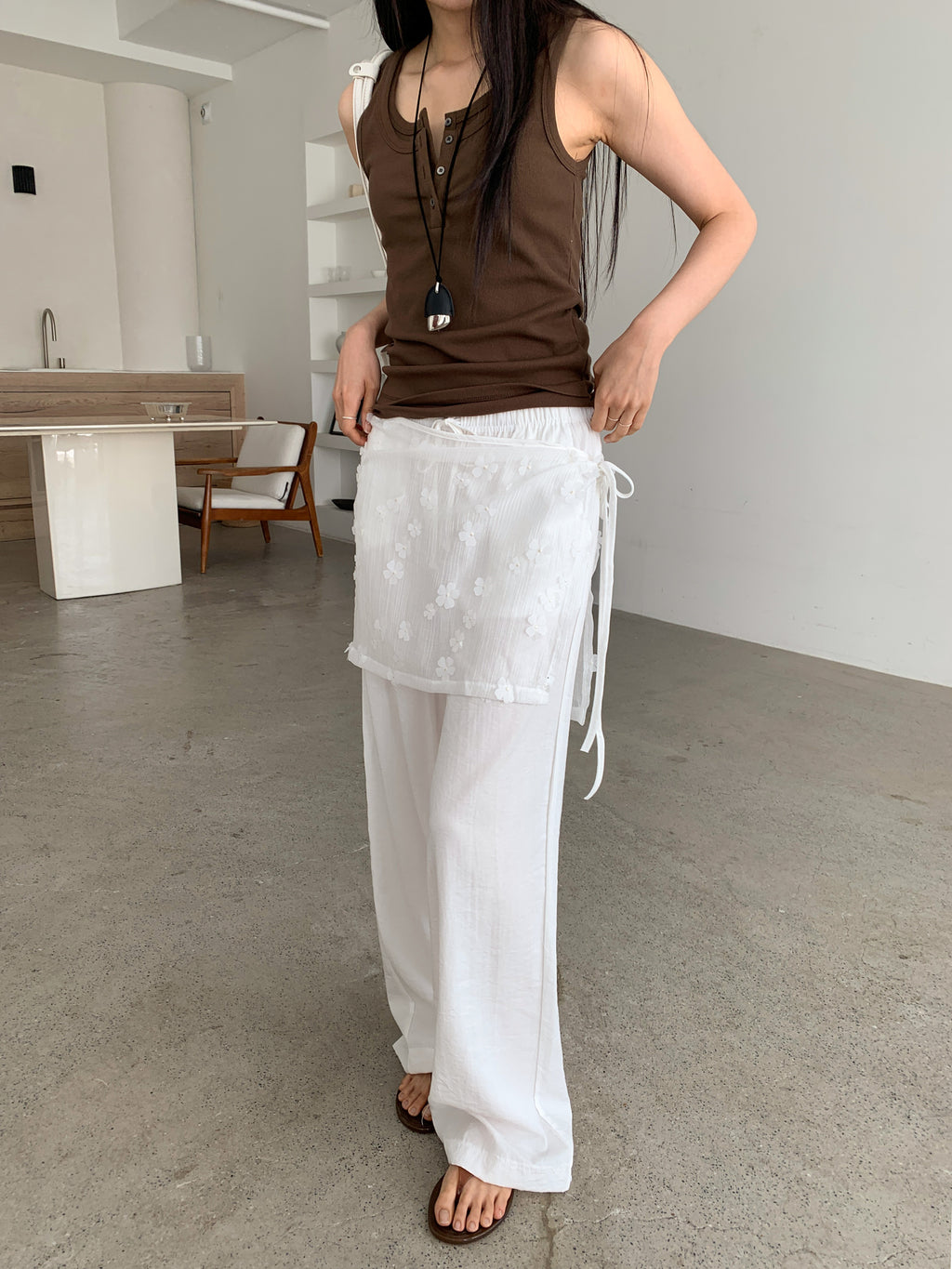 Merrymore floral overlay wrap layered wide leg pants in White, styled on model front view close-up floral jacquard overlay and tie detail with brown tank top