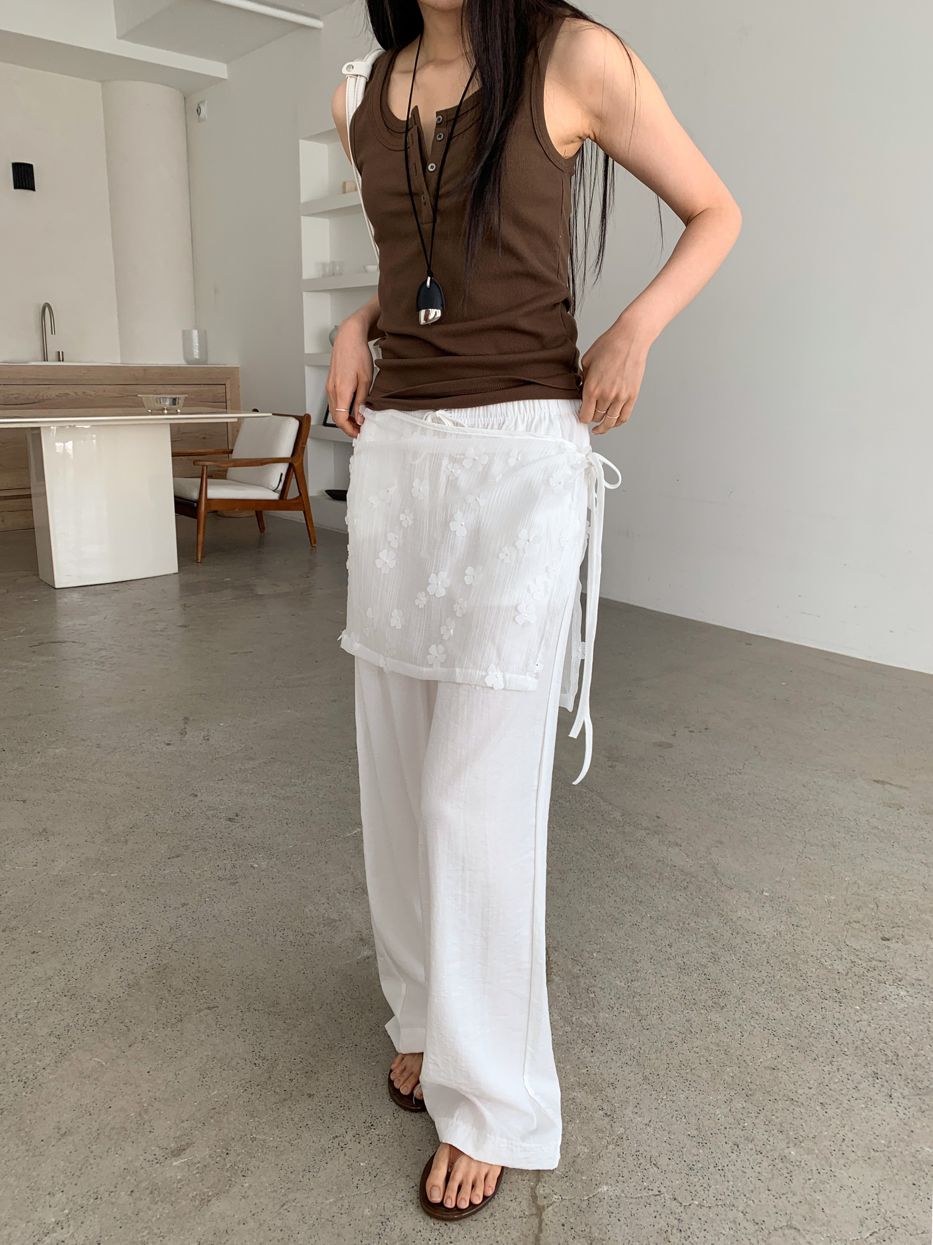 Merrymore floral overlay wrap layered wide leg pants in White, styled on model front view close-up floral jacquard overlay and tie detail with brown tank top