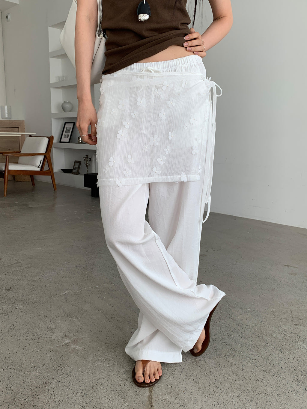 Merrymore floral overlay wrap layered wide leg pants in White, styled on model side view full length with brown tank top showing wide leg silhouette