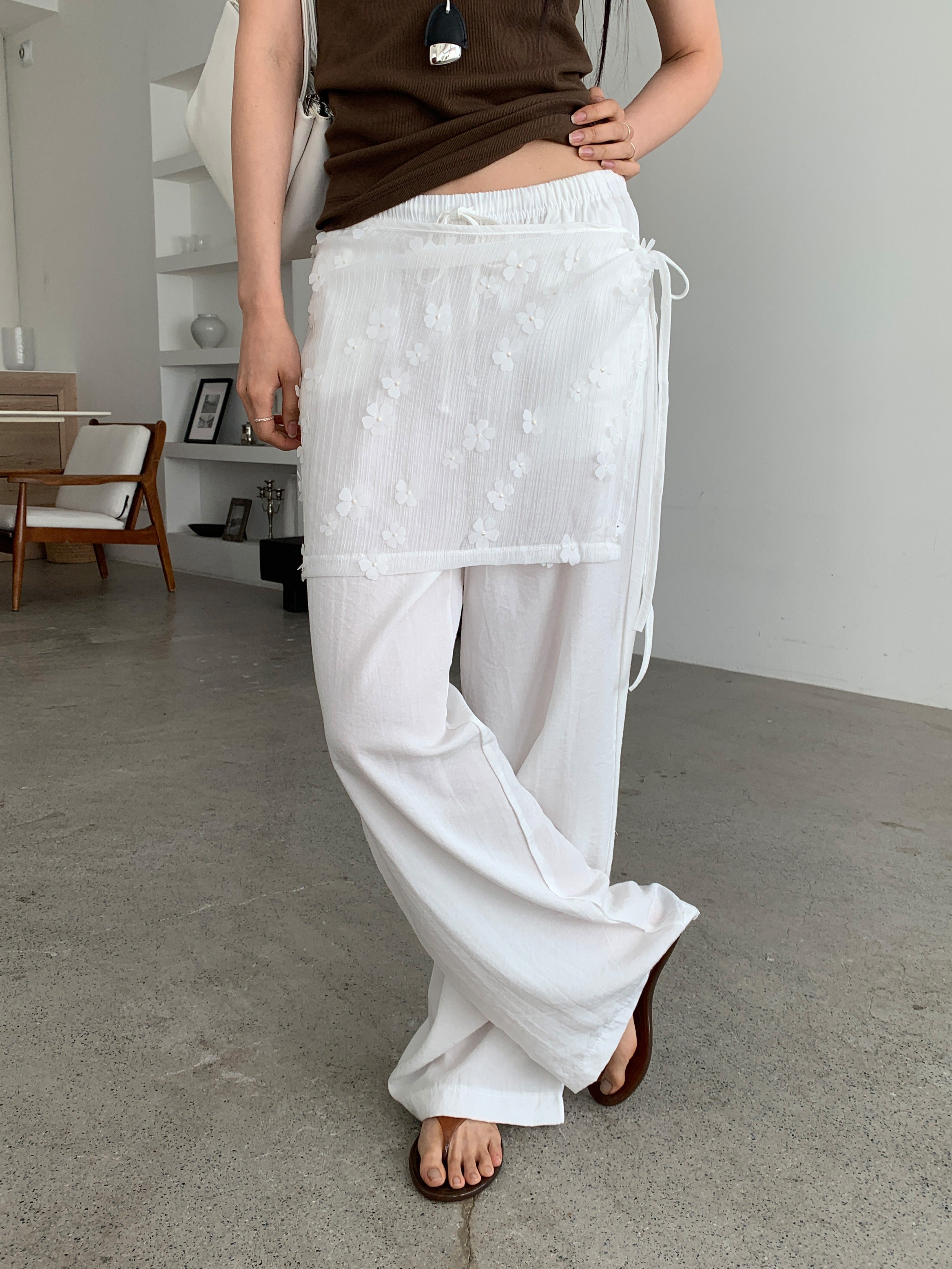Merrymore floral overlay wrap layered wide leg pants in White, styled on model side view full length with brown tank top showing wide leg silhouette