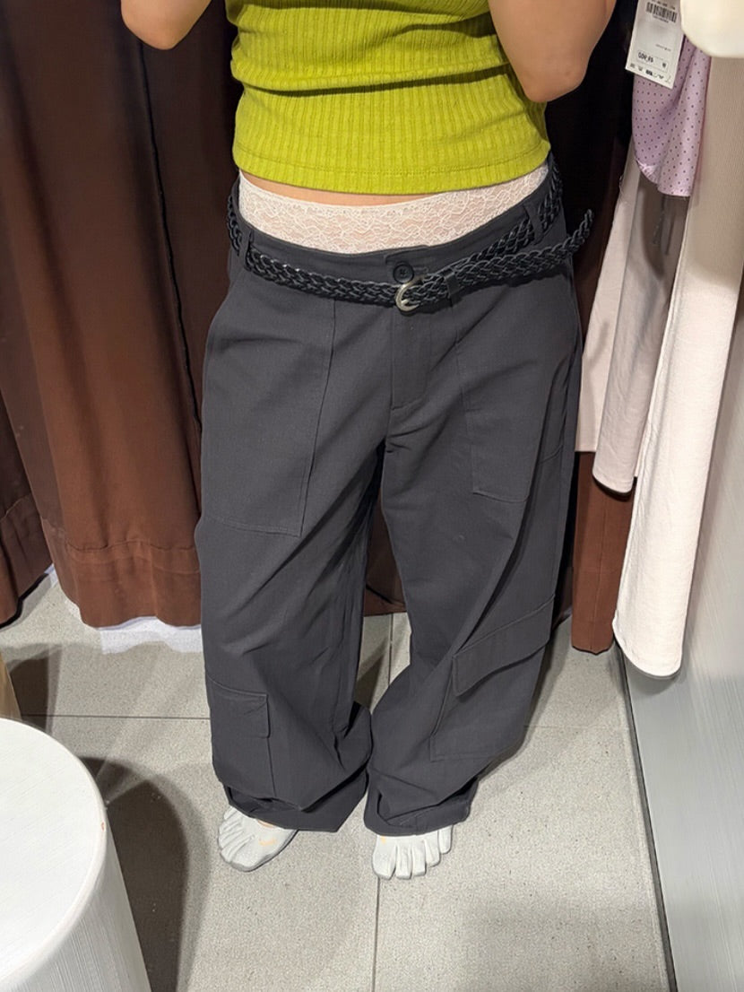 Vivel multi cargo pocket wide leg pants in Charcoal, styled on model front view with white graphic tee and black bag