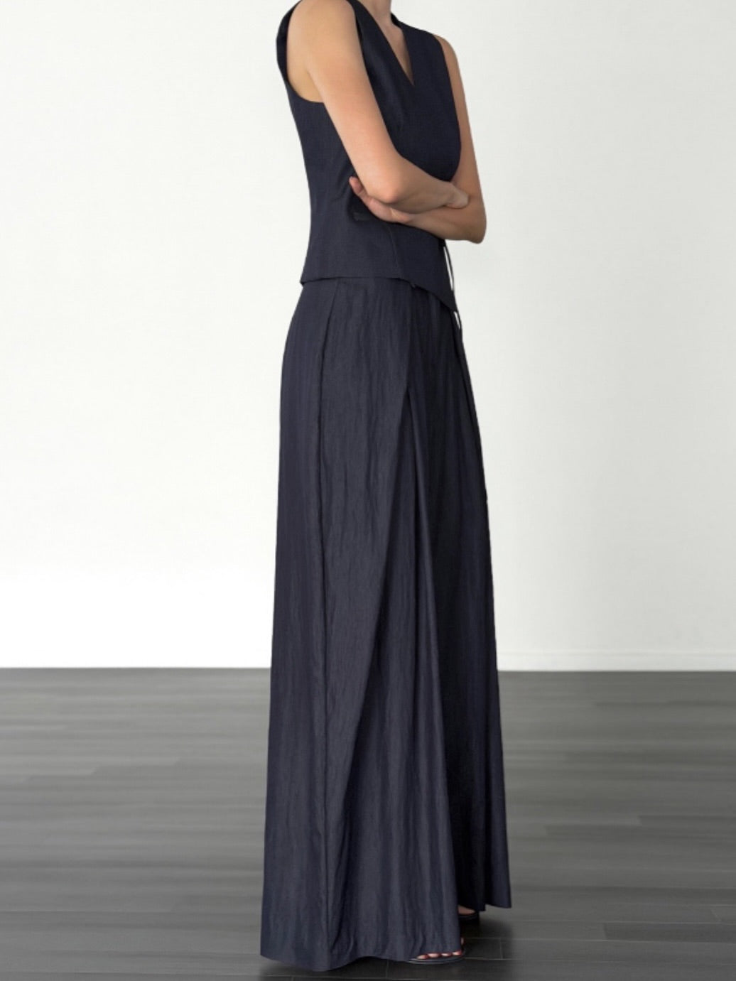 Vivel high waist deep pleat wide leg pants in Navy, styled on model side view with navy wrap top full length