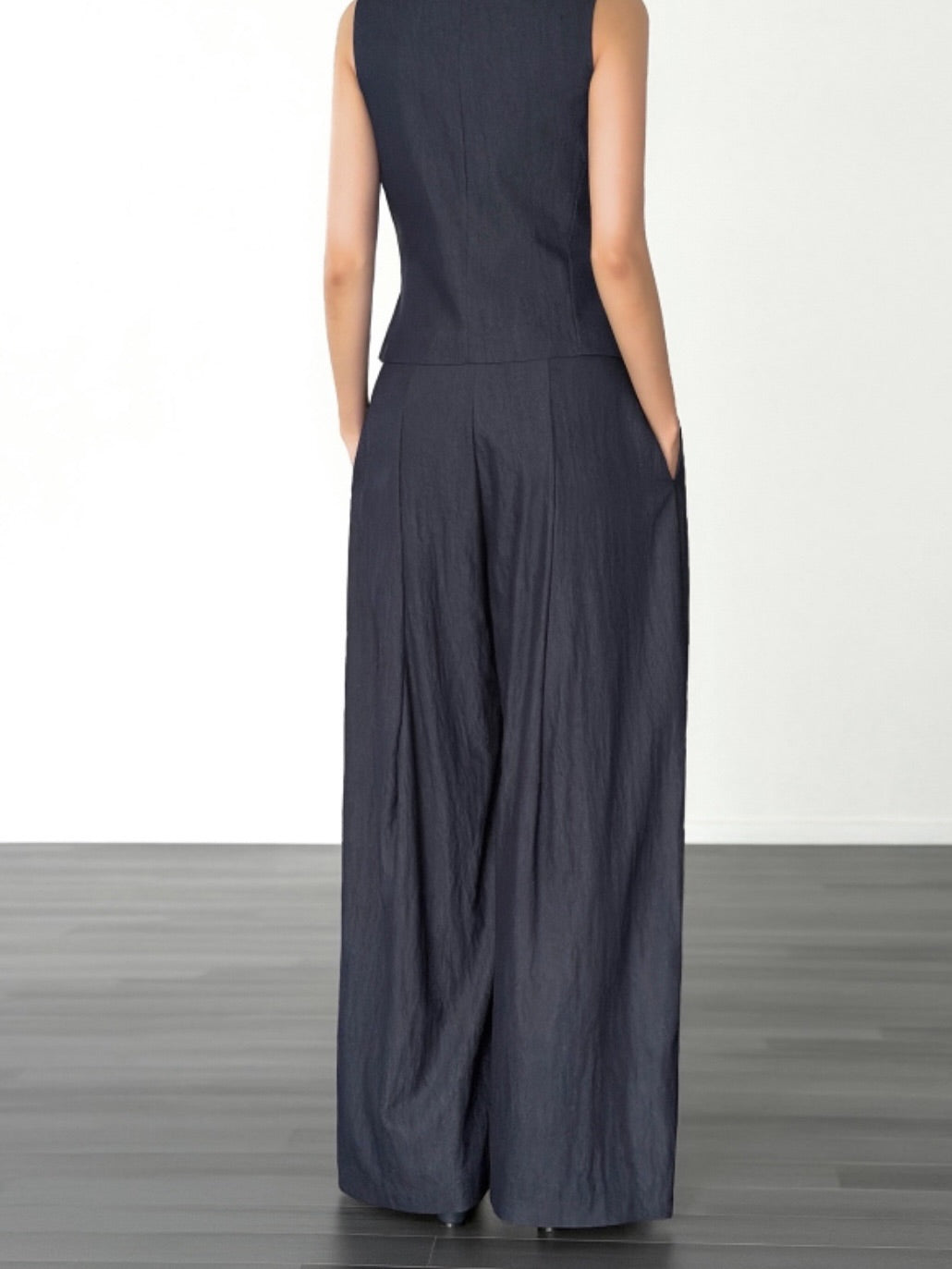 Vivel high waist deep pleat wide leg pants in White, styled on model front view with blue ribbed crop top full length
