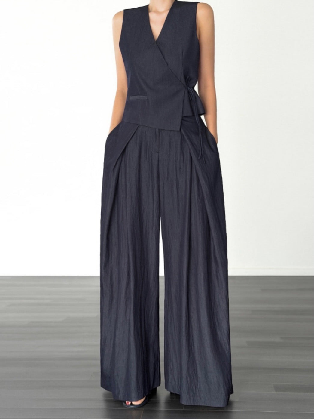 Vivel high waist deep pleat wide leg pants in White, styled on model front view with blue ribbed crop top arms at side full length