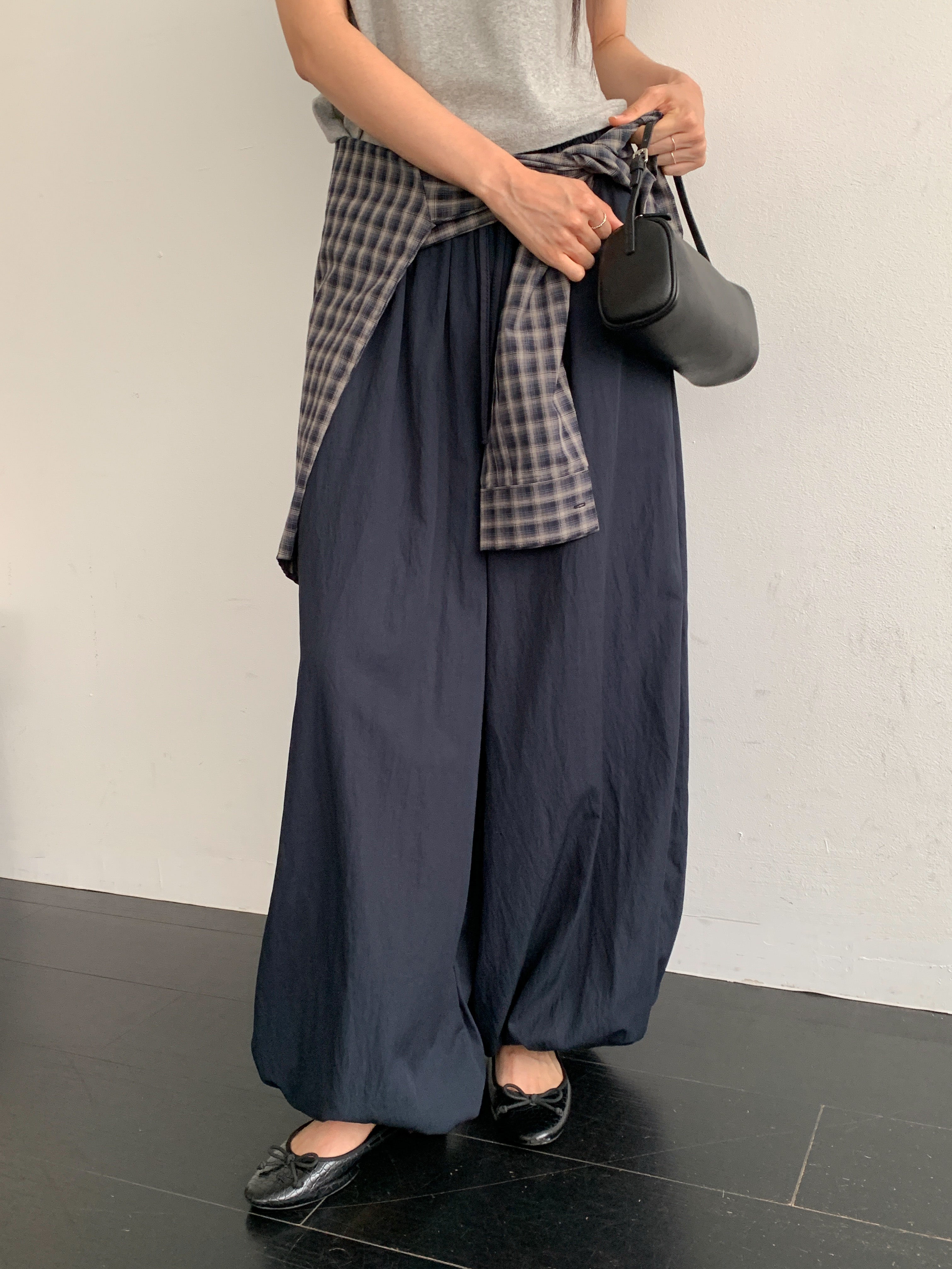 Merrymore drawstring elastic waist harem pants in Black, Navy, Ivory and Burgundy, four colorways product flat lay on grey surface