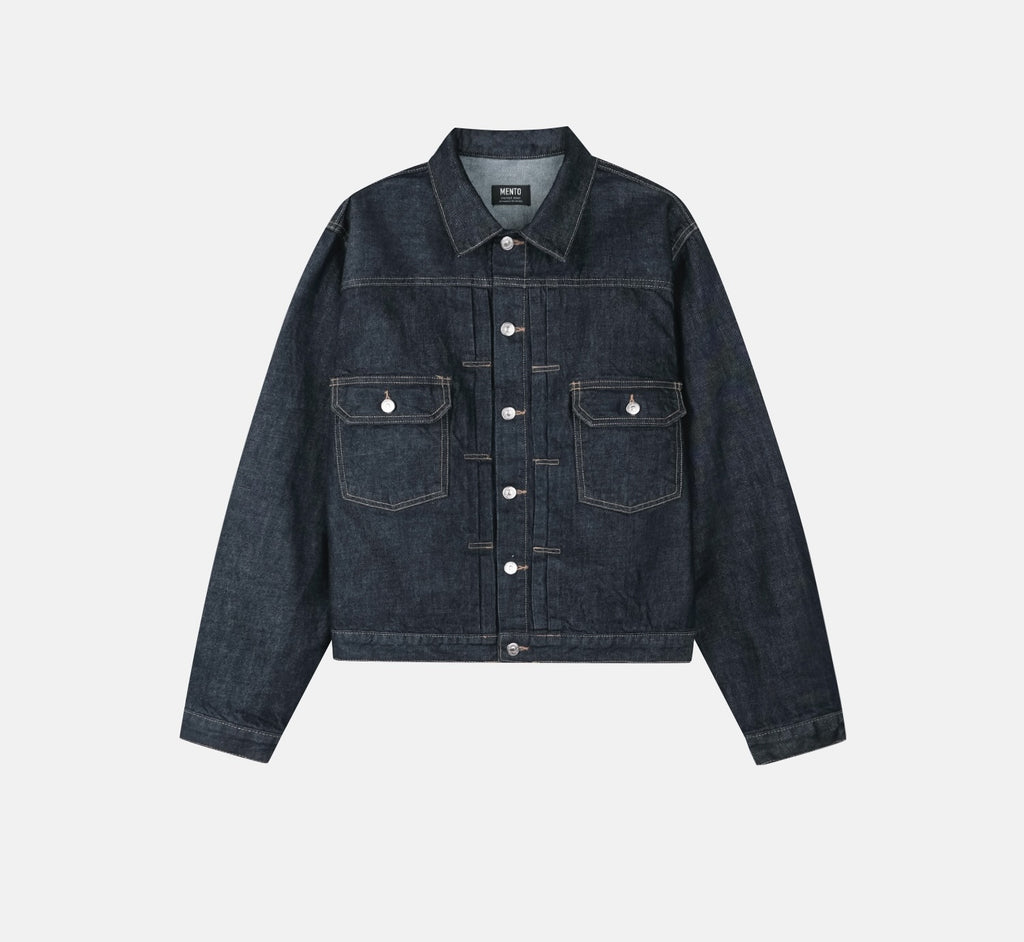 Buttoned cuff and contrast stitching on a raw indigo cotton denim jacket