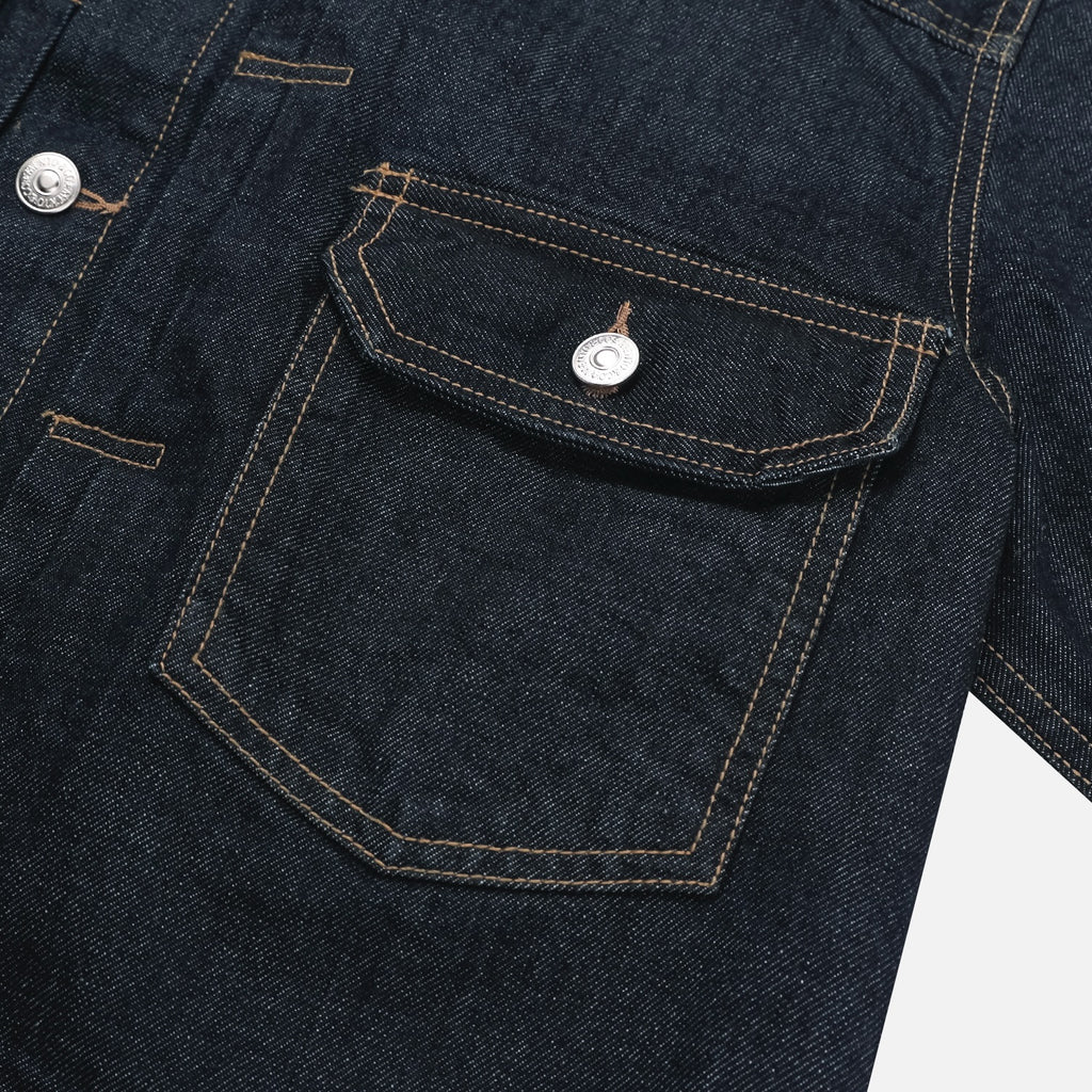 Back view of dark indigo men's trucker denim jacket