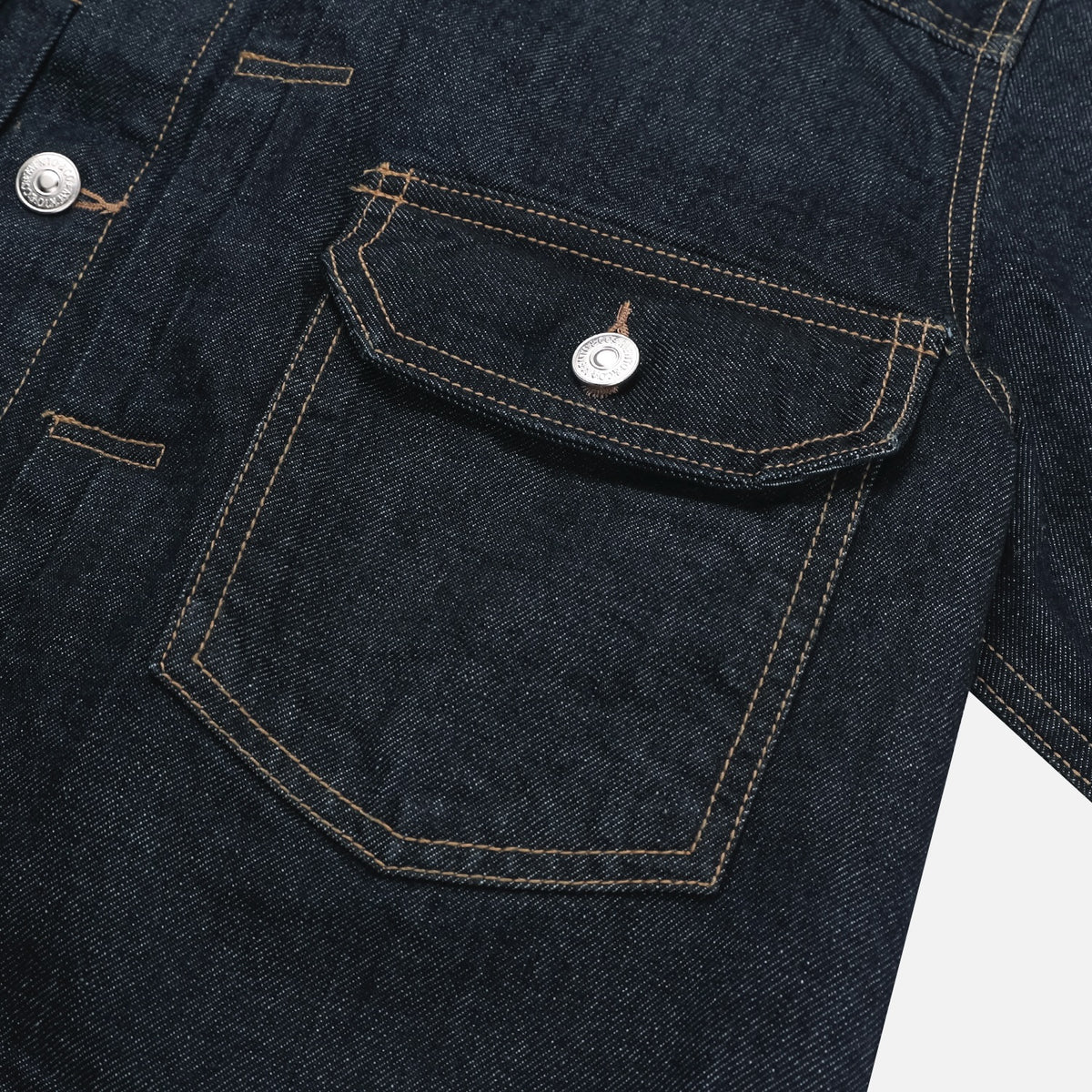 Back view of dark indigo men's trucker denim jacket
