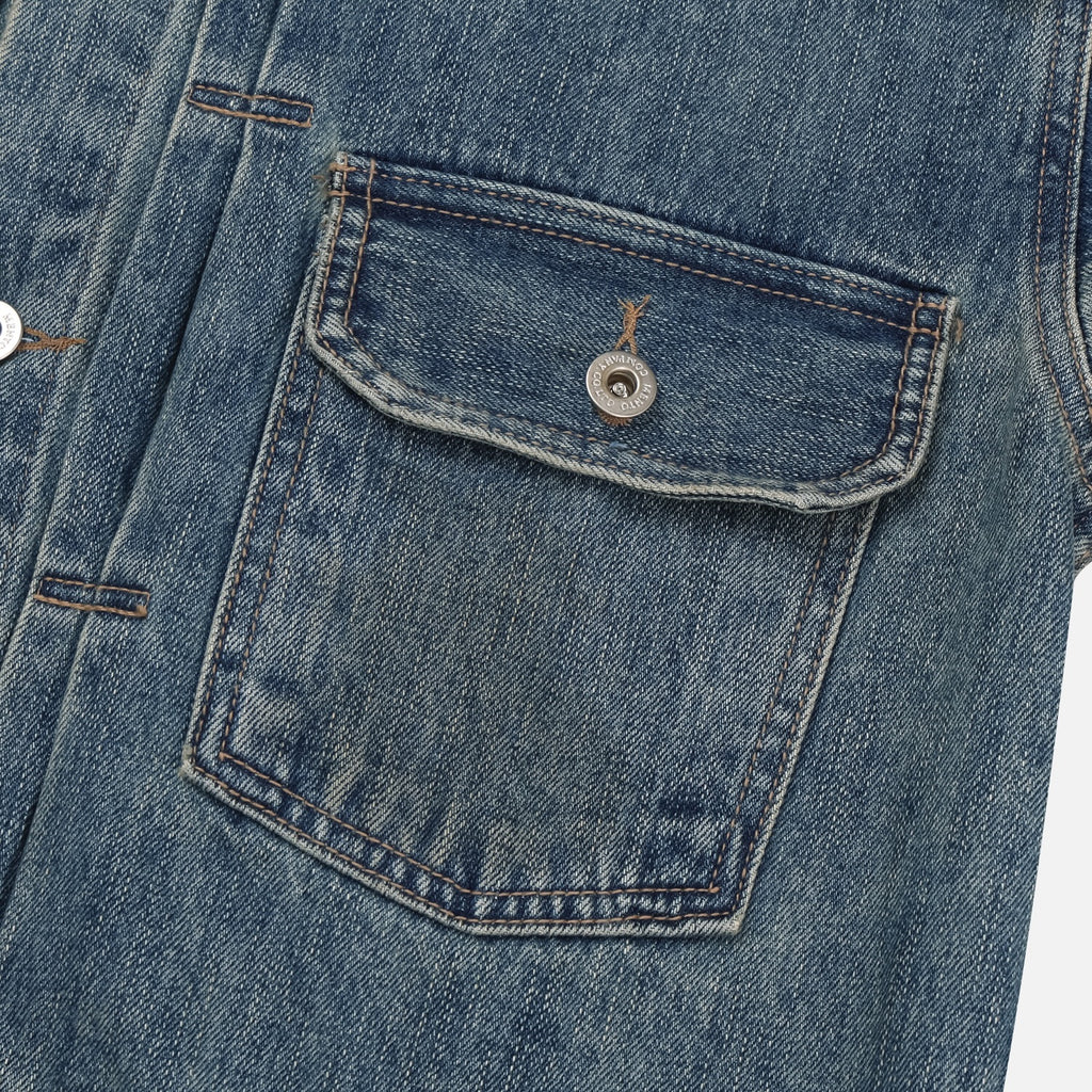 Back yoke and washed cotton denim detail on a mid-blue trucker jacket