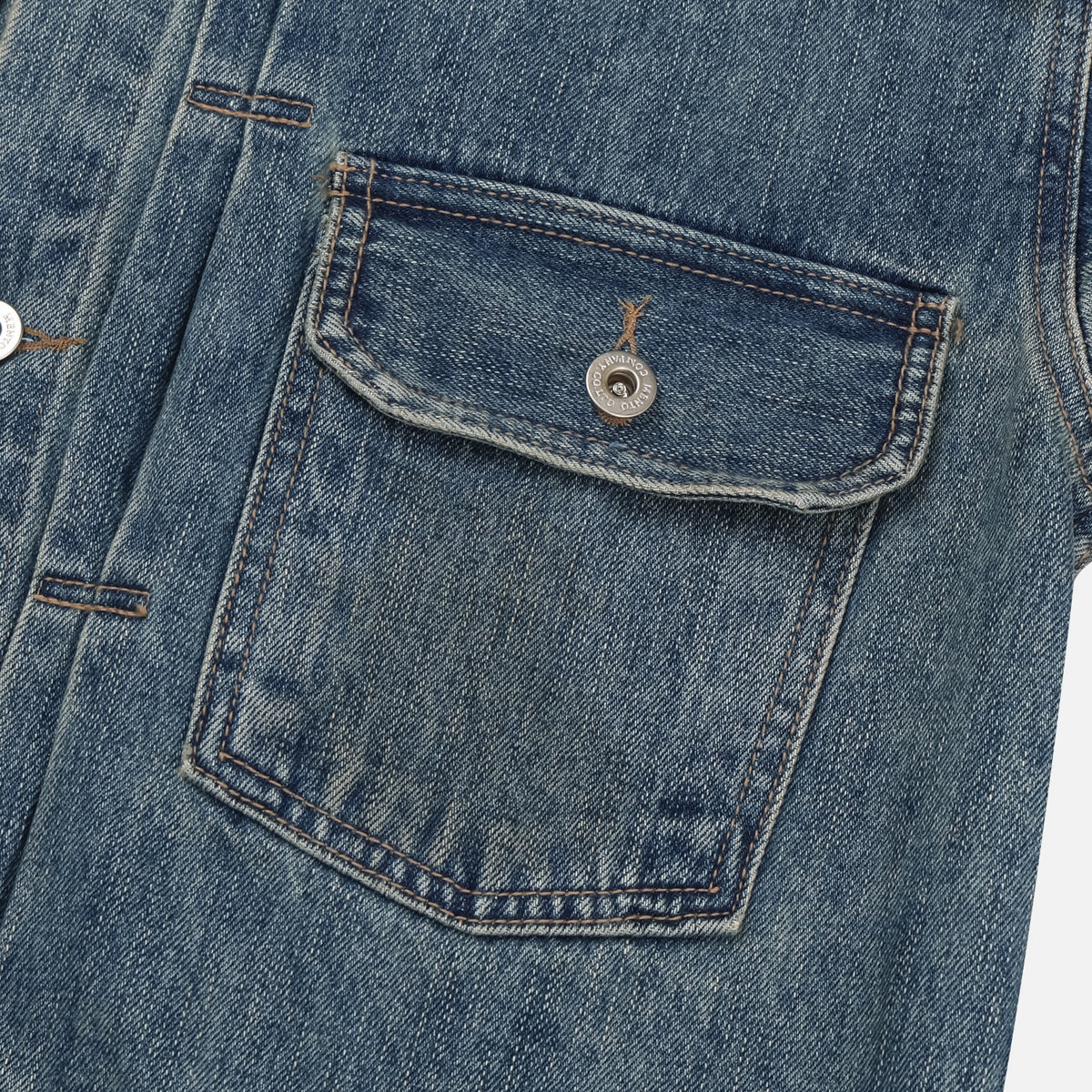 Back yoke and washed cotton denim detail on a mid-blue trucker jacket