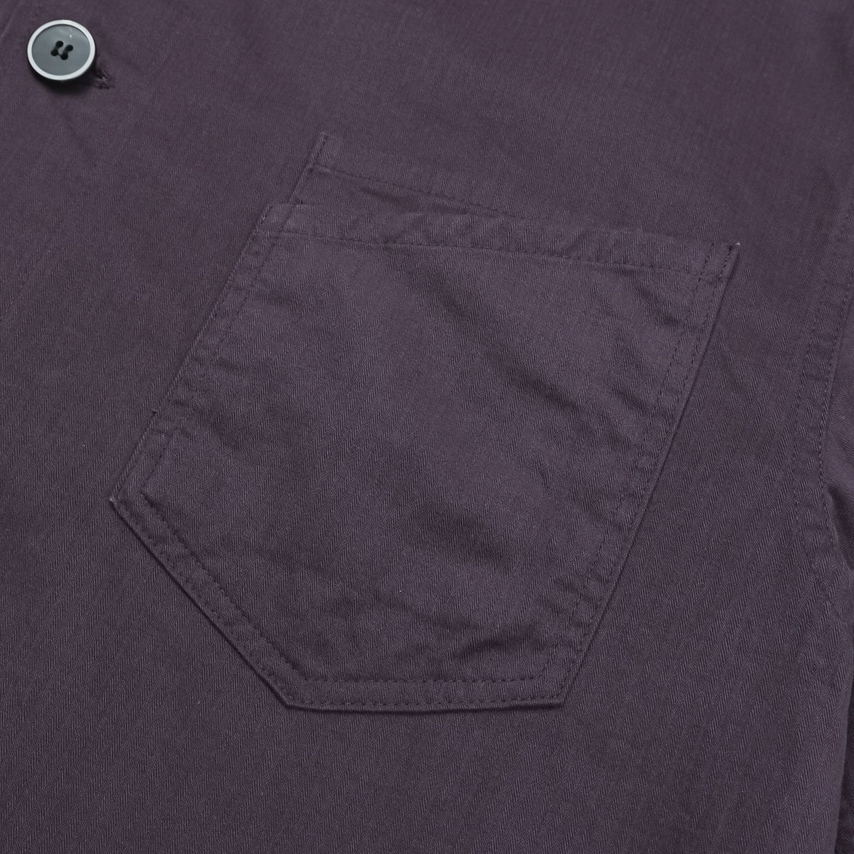 Straight hem and stitching detail on a purple cotton shirt jacket