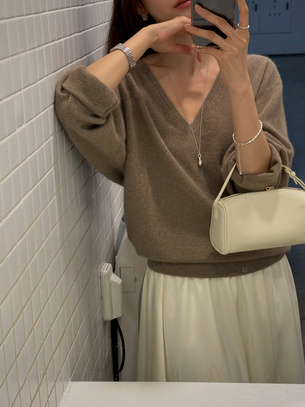 V-Neck Racoon Knit Sweater Grey on chair