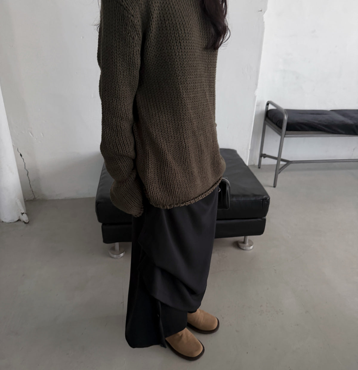 Charcoal and black maxi skirts on hangers showing gathered side styling.