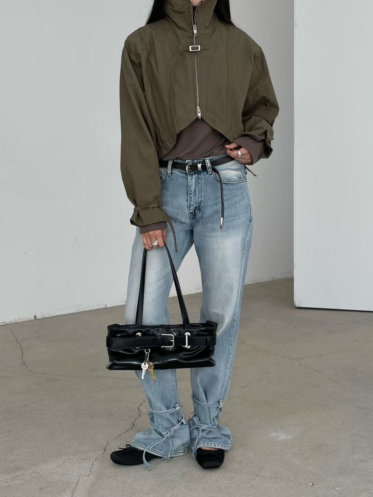 Khaki cropped bolero jacket with stand collar styled with light blue jeans
