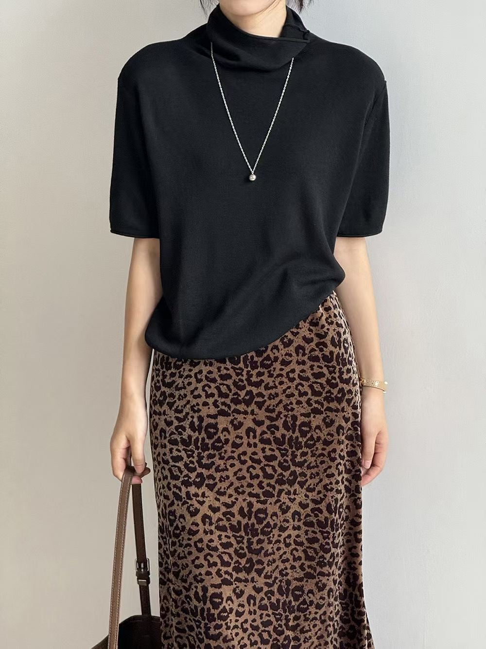 Stayhere short sleeve mock neck sweaters in Ivory, Brown, Charcoal and Black on hangers.