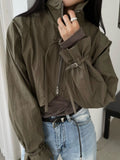 Khaki cropped bolero jacket, close-up of stand collar, zip and buckle cuff