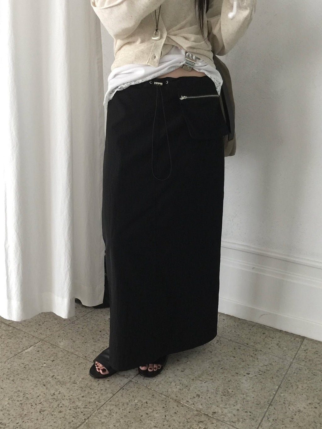 Nweol low rise zip pocket maxi skirt in Black, front slit detail close-up