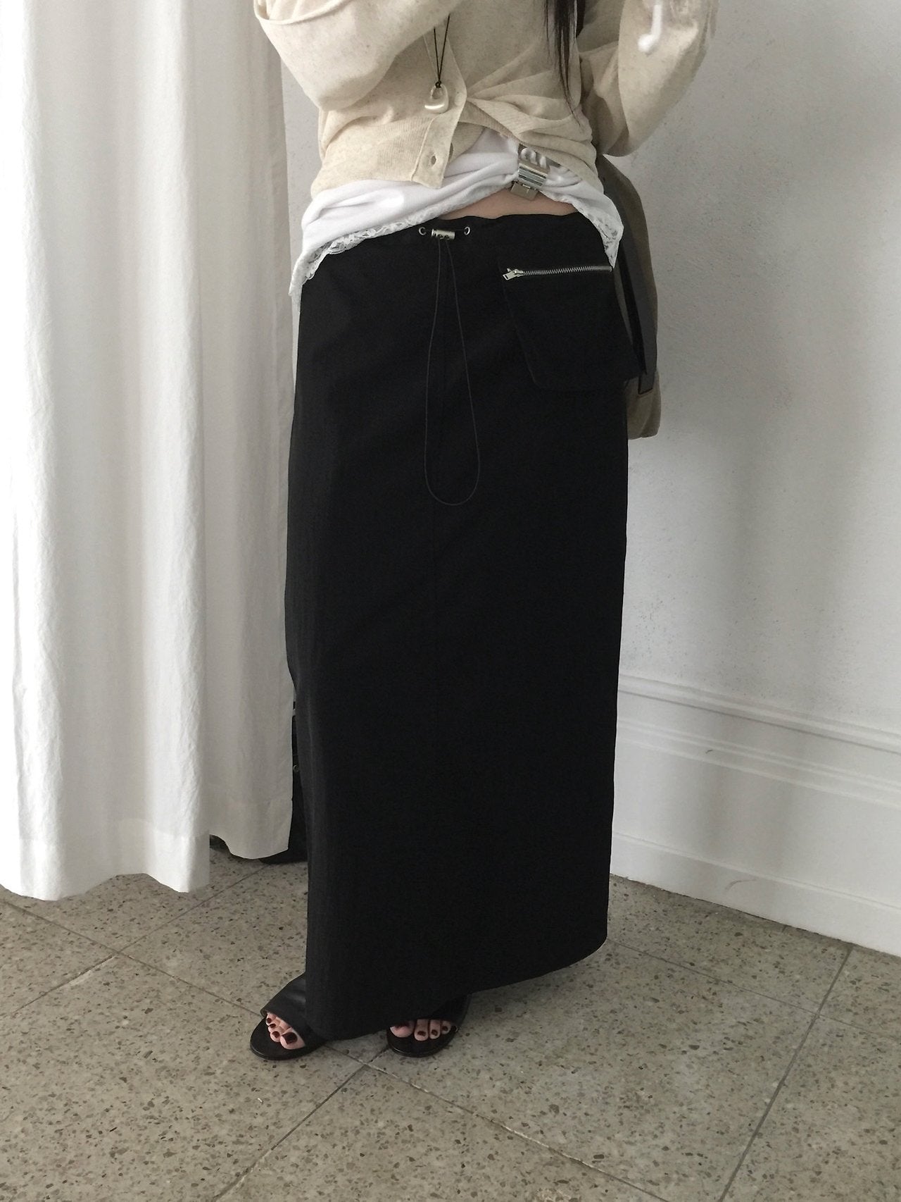 Nweol low rise zip pocket maxi skirt in Black, front slit detail close-up