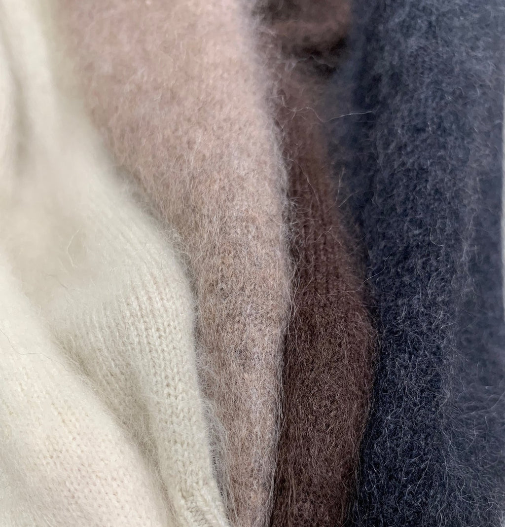 Brown V-neck sweater layered over a blue top