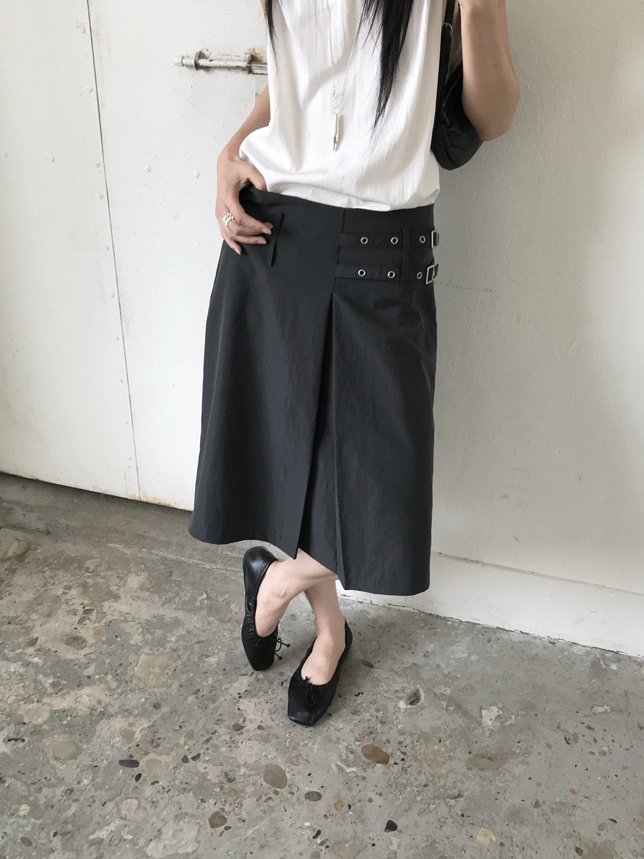 Newol Double Buckle Eyelet Pleated Midi Skirt — Asymmetric Hem