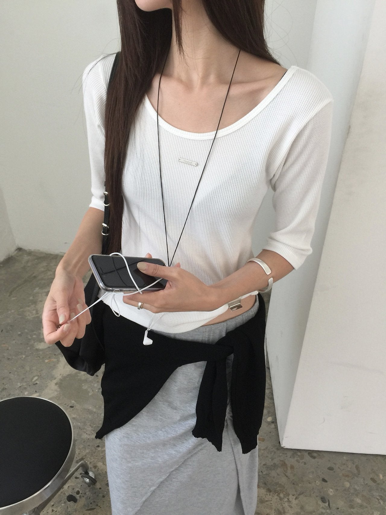 Nweol waffle knit crop top in Charcoal, flat lay on black bench front view