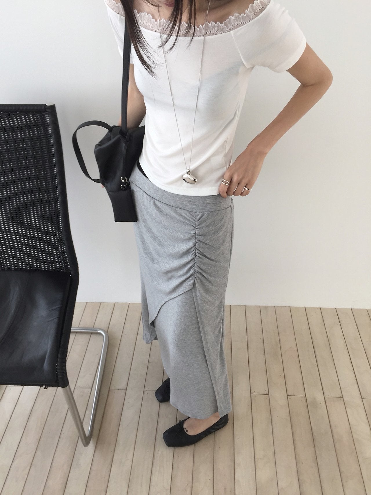 Nweol side ruched maxi skirt in Grey, styled on model front view with white off-shoulder top and black loafers