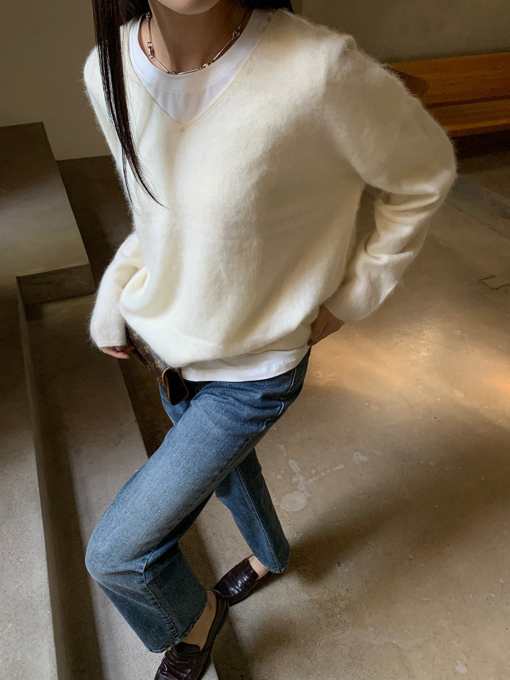 Side view of mocha long-sleeve knit sweater