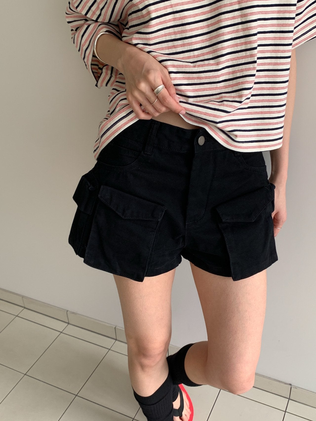 Vive L cargo shorts in Brown, flat lay on hanger with brand tag